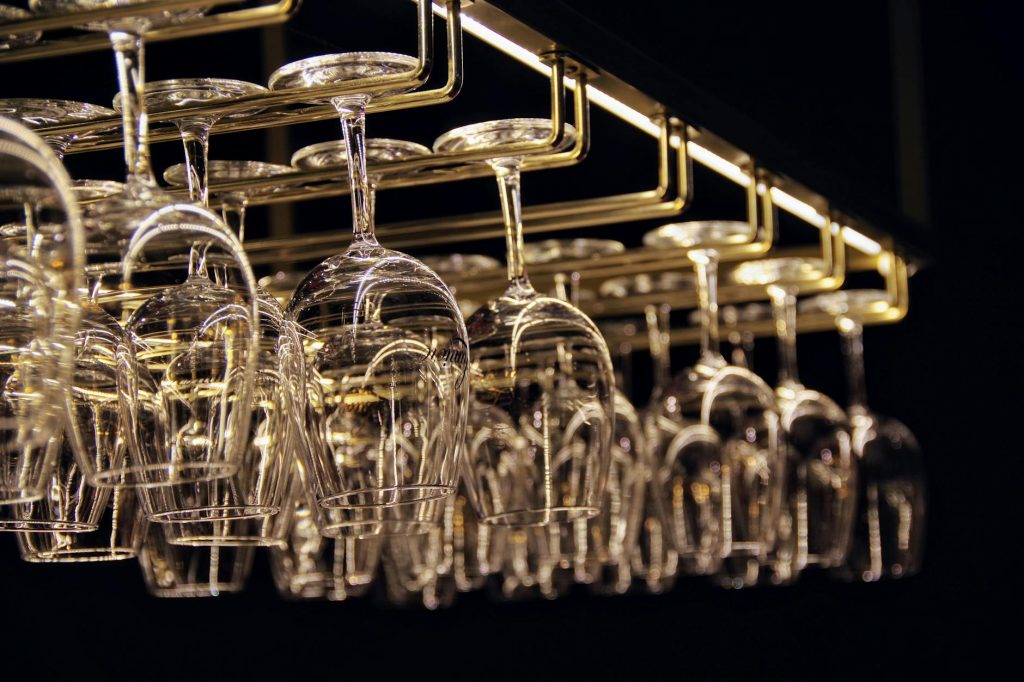 set of elegant glasses hanging on metal rack